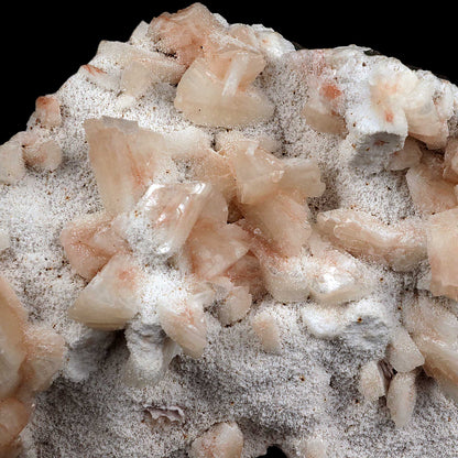 Heulandite crystals on Mordenite Natural Mineral Specimen # B 3722  https://www.superbminerals.us/products/heulandite-crystals-on-mordenite-natural-mineral-specimen-b-3722  Features:This neat specimen from India appears to be a combination of a heulandite crystal and chalcedony stalactites. Heulandite usually occurs in a very glossy pyramidal type crystal. This is a very nice specimen with no damage to the crystal. Peach colored crystals of heulandite on a white mordenite matrix. 