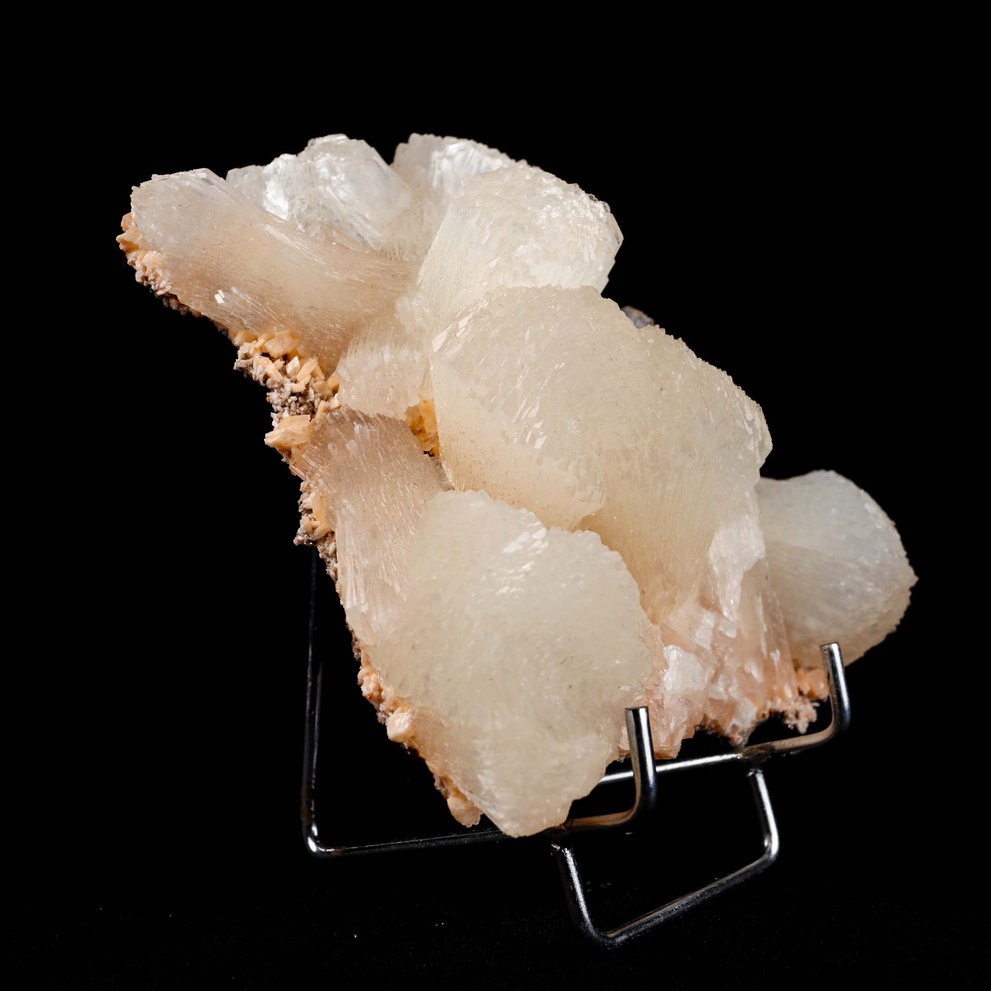 lustrous Terminated Stilbite Natural Mineral Specimen # B 4989  https://www.superbminerals.us/products/lustterorus-terminated-stilbite-natural-mineral-specimen-b-4989  Features:&nbsp;Featuring many excellent quality bladed groups of Stilbite in a soft white hue, resting over pearly stalactitic formations of peach colored Heulandite, this piece is a stunning example of the material. The sculpture is really flashy and three-dimensional, and I particularly like how the Stilbites