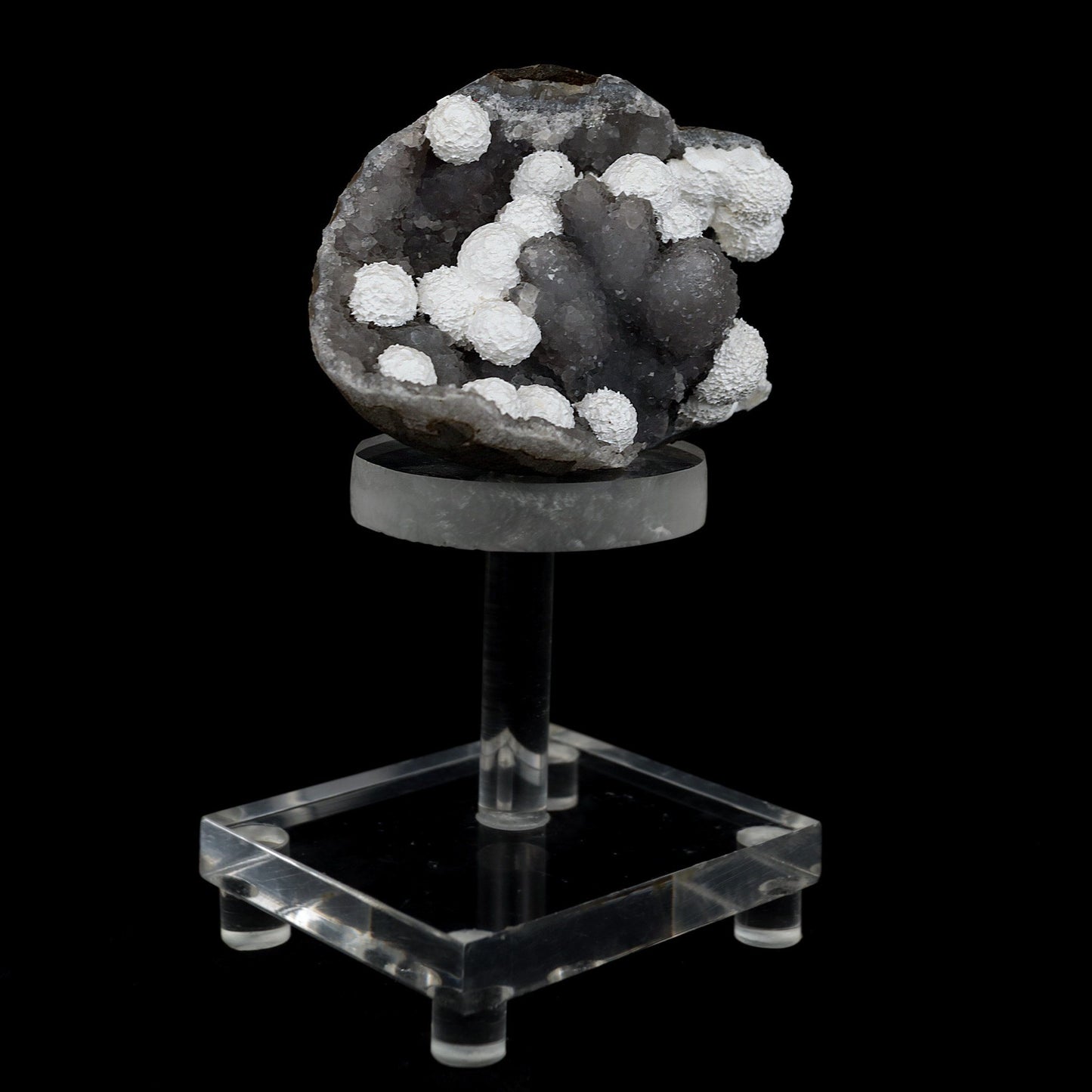 Okenite Balls on MM Quartz Natural Mineral Specimen # B 4439  https://www.superbminerals.us/products/okenite-balls-on-mm-quartz-natural-mineral-specimen-b-4439  Features: Beautiful snow-white puff balls of needle Okenite are scattered over all, In this stunning cavernous Chalcedony matrix. Such outstanding Okenite specimens. Primary Mineral(s): OkeniteSecondary Mineral(s): N/AMatrix: MM Quartz11 cm x 7 cm x 7 cmWeight : 310 Gms Locality: Mumbai, Maharashtra, 