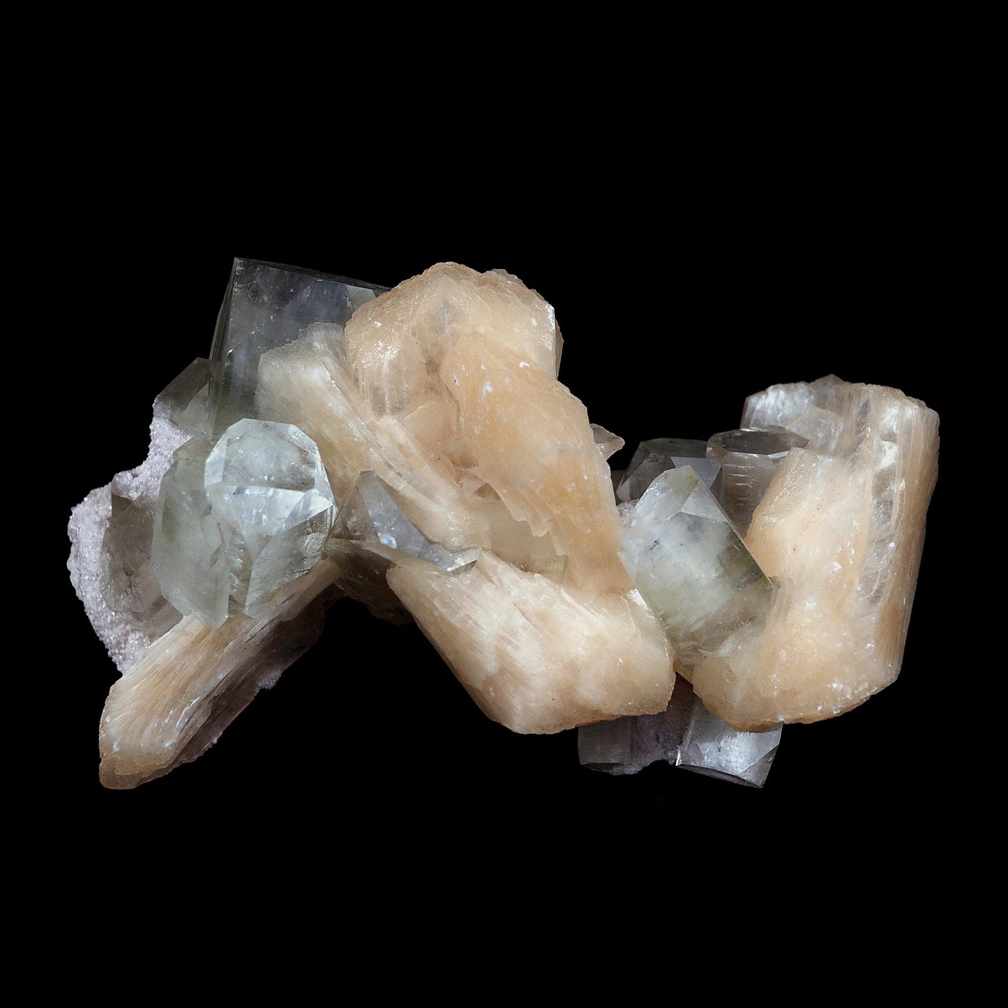 Pink Stilbite with Apophyllite Natural Mineral Specimen # B 4597  https://www.superbminerals.us/products/pink-stilbite-with-apophyllite-natural-mineral-specimen-b-4597  Features:A classic show specimen with crisp, gemmy to colourless Apophyllite crystals on matrix and peach tinted Stilbite. Overall, the work is in good condition, and its displayability is unquestionably above average. However, you cannot dispute that they are vibrant, appealing, and extremely visible.