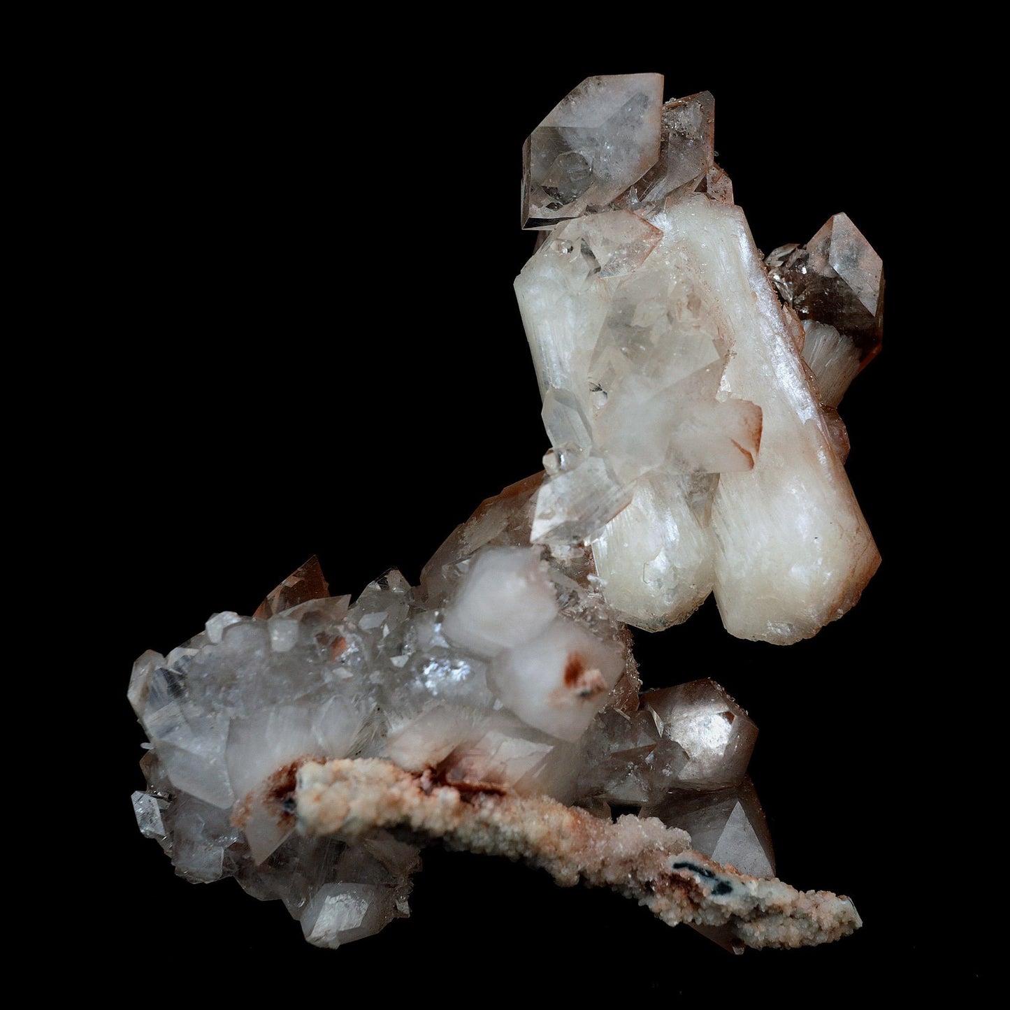 Pointed Apophyllite with Stilbite On Chalcedony Natural Mineral # B 41…  https://www.superbminerals.us/products/pointed-apophyllite-with-stilbite-on-chalcedony-natural-mineral-b-4176  Features:This specimen is mainly composed of the white/clear Apophyllite with inclusions of red hematite which transform partially red crystal and accented with the beautiful peachy colored stilbite that grew along with it. That being said, it was pieced back together seamlessly and is an extraordinary specimen
