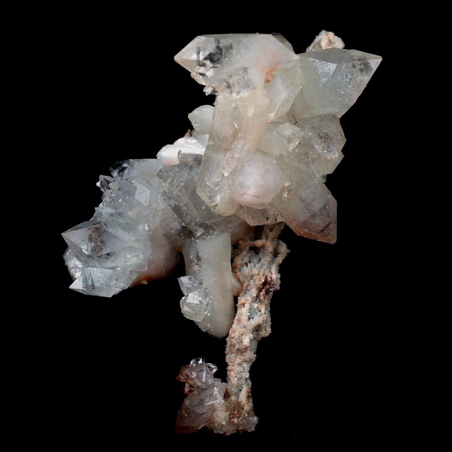 Pointed Apophyllite with Stilbite On Chalcedony Stalactite # B 4179  https://www.superbminerals.us/products/pointed-apophyllite-with-stilbite-on-chalcedony-stalactite-b-4179  Features:Very fine classic Apophyllite specimen with Stilbite on Quartz from the Jalgaon area Deccan Trap flood Basalts. Sharply formed crystals of Apophyllite, displaying strong development of prism and pyramidal faces. Crystals of Apophyllite have pleasing color less gemmy pyramidal areas due to hematite inclusions 