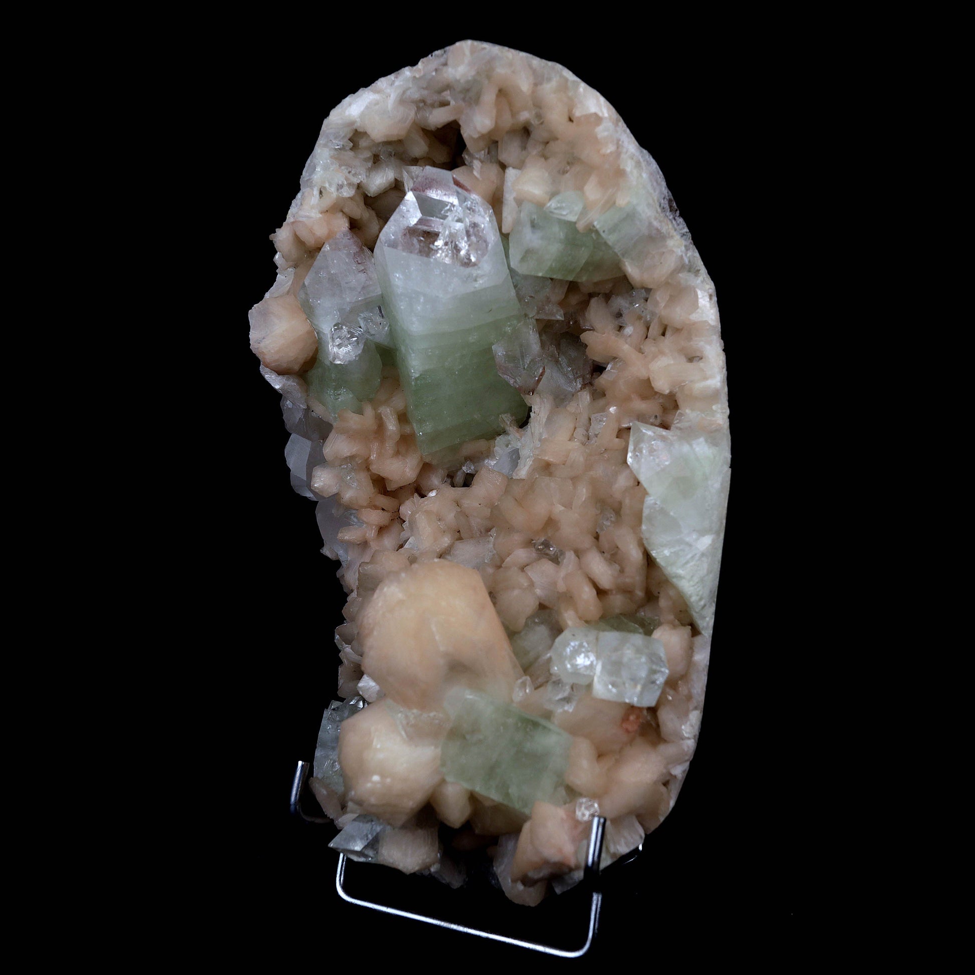 Pointed Green Apophyllite with Stilbite Inside Geode Natural Mineral S…  https://www.superbminerals.us/products/pointed-green-apophyllite-with-stilbite-inside-geode-natural-mineral-specimen-b-4385  Features:Beautiful gemmy and lustrous, bi-colored tetragonal pyramidal fluorapophyllite crystals are very aesthetically set amidst a dense lining of pearlescent flesh-pink stilbites on this dramatic rich pocket from recent finds at Jalgaon. The impressive large upright apophyllite.Primary Mineral(s): Apophyllite
