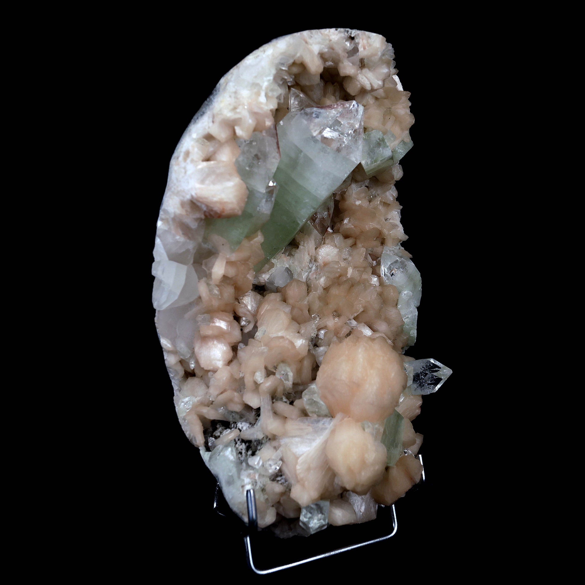 Pointed Green Apophyllite with Stilbite Inside Geode Natural Mineral S…  https://www.superbminerals.us/products/pointed-green-apophyllite-with-stilbite-inside-geode-natural-mineral-specimen-b-4385  Features:Beautiful gemmy and lustrous, bi-colored tetragonal pyramidal fluorapophyllite crystals are very aesthetically set amidst a dense lining of pearlescent flesh-pink stilbites on this dramatic rich pocket from recent finds at Jalgaon. The impressive large upright apophyllite.Primary Mineral(s): Apophyllite