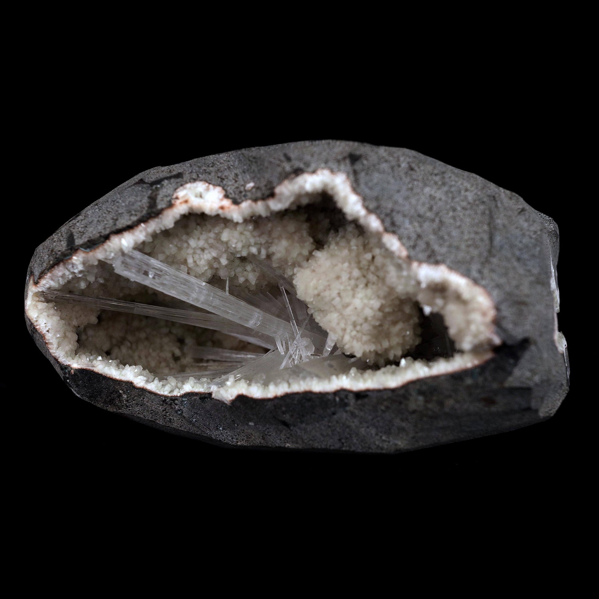 Scolecite Sprays Inside Geode Natural Mineral Specimen # B 4649  https://www.superbminerals.us/products/scolecite-sprays-inside-geode-natural-mineral-specimen-b-4649  Features: A lovely item with a geode lined with beige, glossy Heulandite crystals. The crystals have a pearly, almost glassy sheen and are highly defined.This item is glistening. Very good condition. Primary Mineral(s): ScoleciteSecondary Mineral(s): N/AMatrix: Heulandite12 cm x 6 cm Weight : 910 Gms Locality: Jalgaon