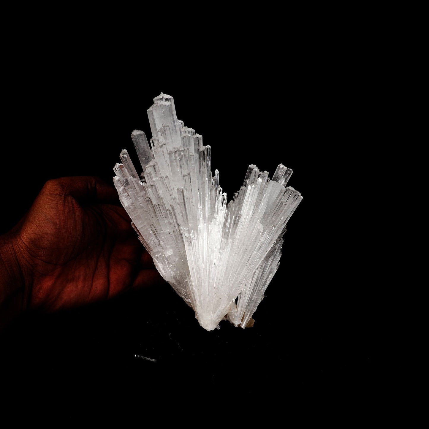 Scolecite Sprays Natural Mineral Specimen # B 5227  https://www.superbminerals.us/products/scolecite-sprays-natural-mineral-specimen-b-5227  Features: A huge, tapering spray of colourless elongated Scolecite crystals. A little fragment of matrix is linked to a small Stilbite crystal. Scolecite crystals have a glassy appearance and are highly translucent, with transparent terminations. A lovely specimen in superb condition. Primary Mineral(s): Scolecite