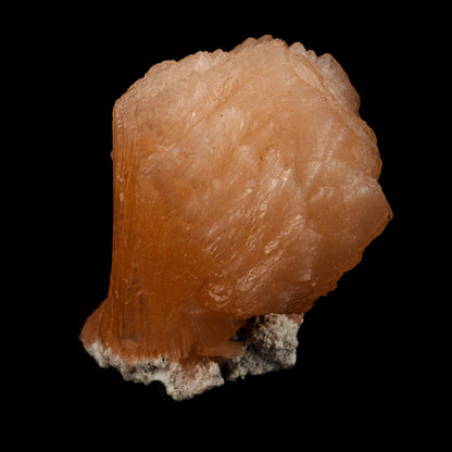 Stilbite Natural Mineral Specimen # B 5099  https://www.superbminerals.us/products/stilbite-natural-mineral-specimen-b-5099  Features: The best viewing angle for this specimen shows a 3-dimensional upright stilbite "bow tie," with a pastel salmon color and great luster and translucence. The matrix is a thin veneer of Heulandite. Primary Mineral(s): Stilbite Secondary Mineral(s): N/AMatrix: N/A 4 Inch x 3 InchWeight : 355 GmsLocality: Jalgaon