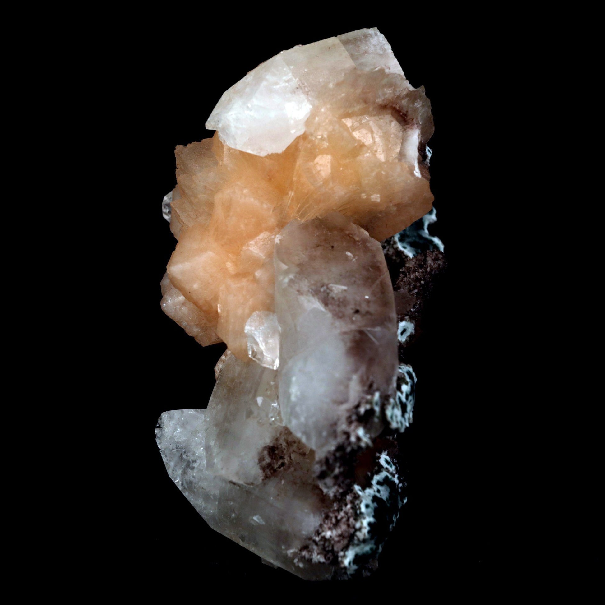 Stilbite with Apophyllite on Chalcedony Natural Mineral Specimen # B …  https://www.superbminerals.us/products/stilbite-with-apophyllite-natural-mineral-specimen-b-4799  Features: An impressive doubly terminated, lustrous salmon-pink bladed stilbite bowtie, nicely accented with side car crystals, is dramatically set on the thin basalt crust on this beautifully sculptural small cabinet from recent finds in Jalgaon. The secondary doubly terminated stilbite. Small stilbite and smaller