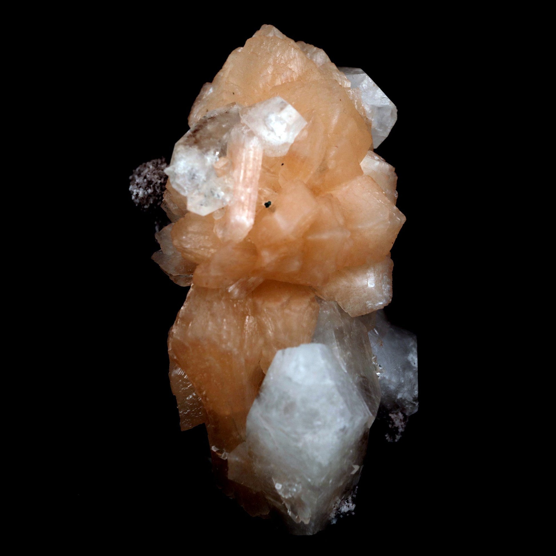 Stilbite with Apophyllite on Chalcedony Natural Mineral Specimen # B …  https://www.superbminerals.us/products/stilbite-with-apophyllite-natural-mineral-specimen-b-4799  Features: An impressive doubly terminated, lustrous salmon-pink bladed stilbite bowtie, nicely accented with side car crystals, is dramatically set on the thin basalt crust on this beautifully sculptural small cabinet from recent finds in Jalgaon. The secondary doubly terminated stilbite. Small stilbite and smaller