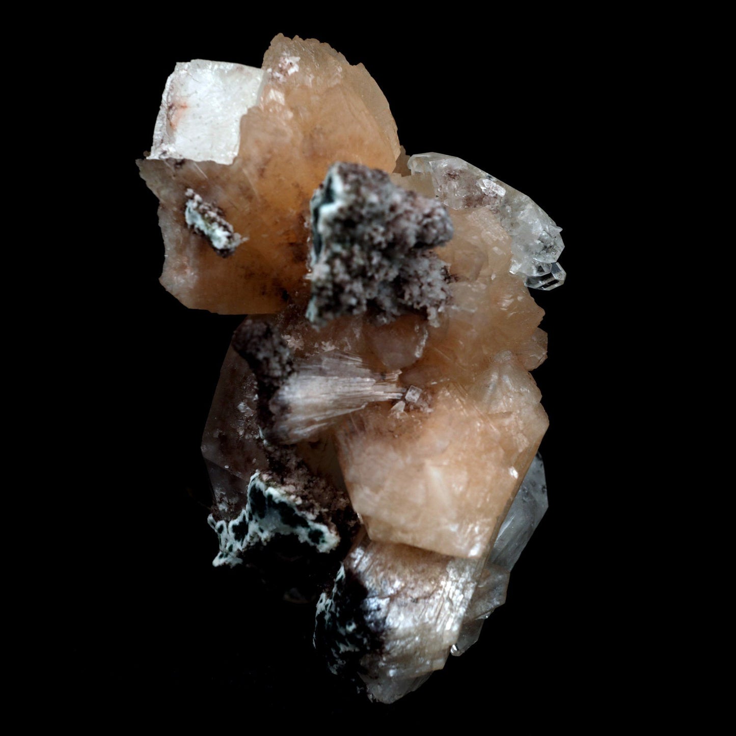 Stilbite with Apophyllite on Chalcedony Natural Mineral Specimen # B …  https://www.superbminerals.us/products/stilbite-with-apophyllite-natural-mineral-specimen-b-4799  Features: An impressive doubly terminated, lustrous salmon-pink bladed stilbite bowtie, nicely accented with side car crystals, is dramatically set on the thin basalt crust on this beautifully sculptural small cabinet from recent finds in Jalgaon. The secondary doubly terminated stilbite. Small stilbite and smaller