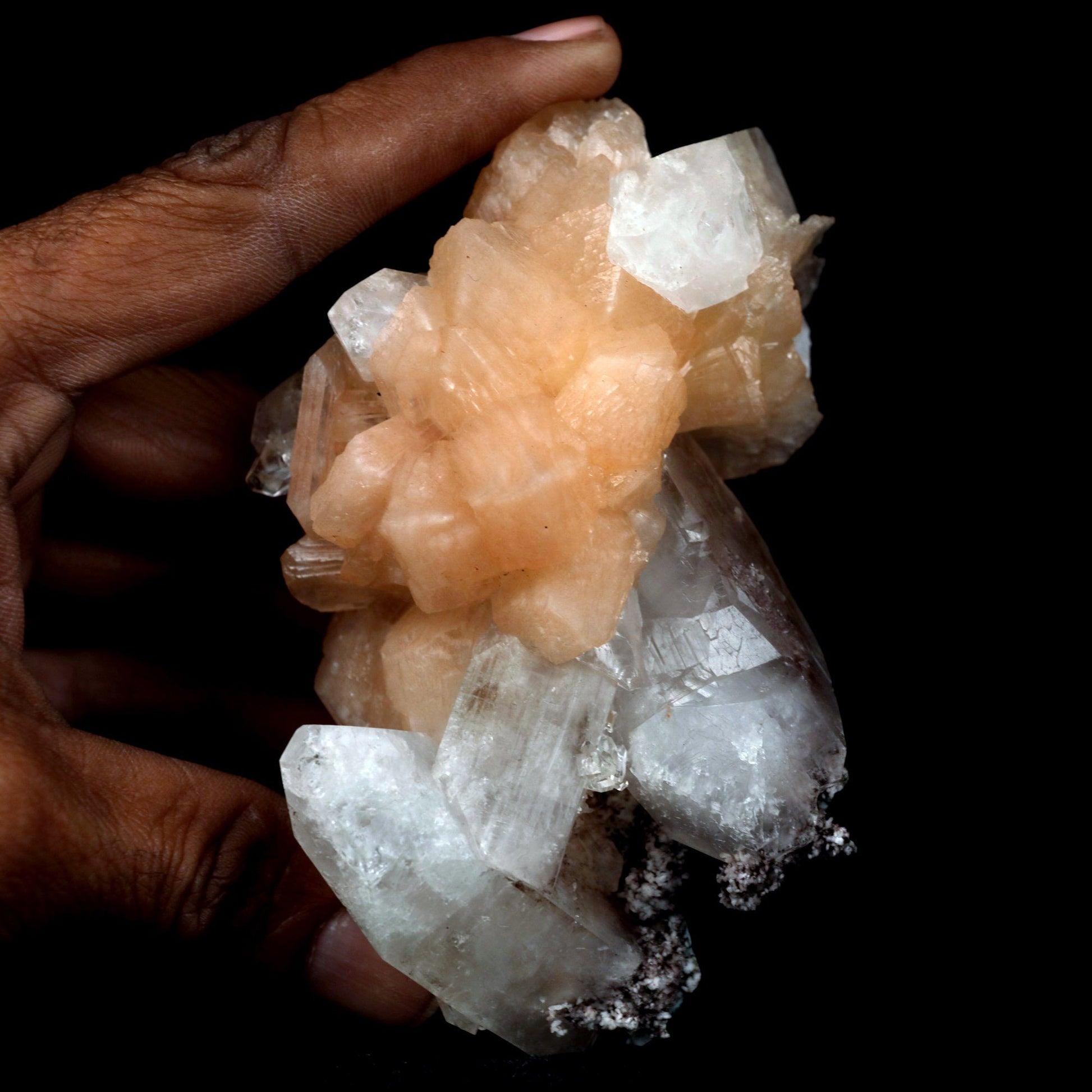 Stilbite with Apophyllite on Chalcedony Natural Mineral Specimen # B …  https://www.superbminerals.us/products/stilbite-with-apophyllite-natural-mineral-specimen-b-4799  Features: An impressive doubly terminated, lustrous salmon-pink bladed stilbite bowtie, nicely accented with side car crystals, is dramatically set on the thin basalt crust on this beautifully sculptural small cabinet from recent finds in Jalgaon. The secondary doubly terminated stilbite. Small stilbite and smaller
