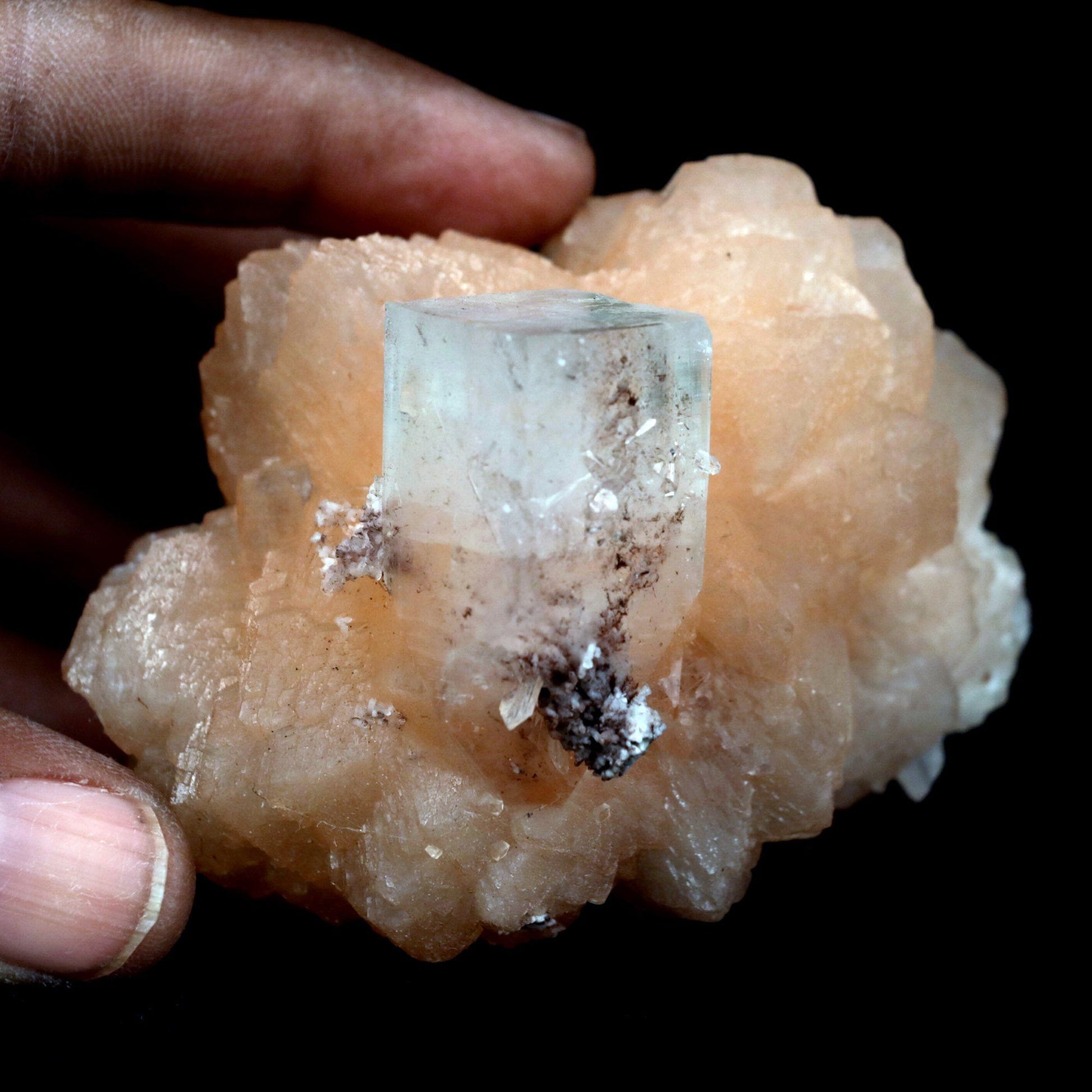 Stilbite with Apophyllite on Chalcedony Natural Mineral Specimen # B …  https://www.superbminerals.us/products/stilbite-with-apophyllite-on-chalcedony-natural-mineral-specimen-b-4800  Features: An impressive doubly terminated, lustrous salmon-pink bladed stilbite bowtie, nicely accented with side car crystals, is dramatically set on the thin basalt crust on this beautifully sculptural small cabinet from recent finds in Jalgaon. The secondary doubly terminated stilbite. Small stilbite and smaller