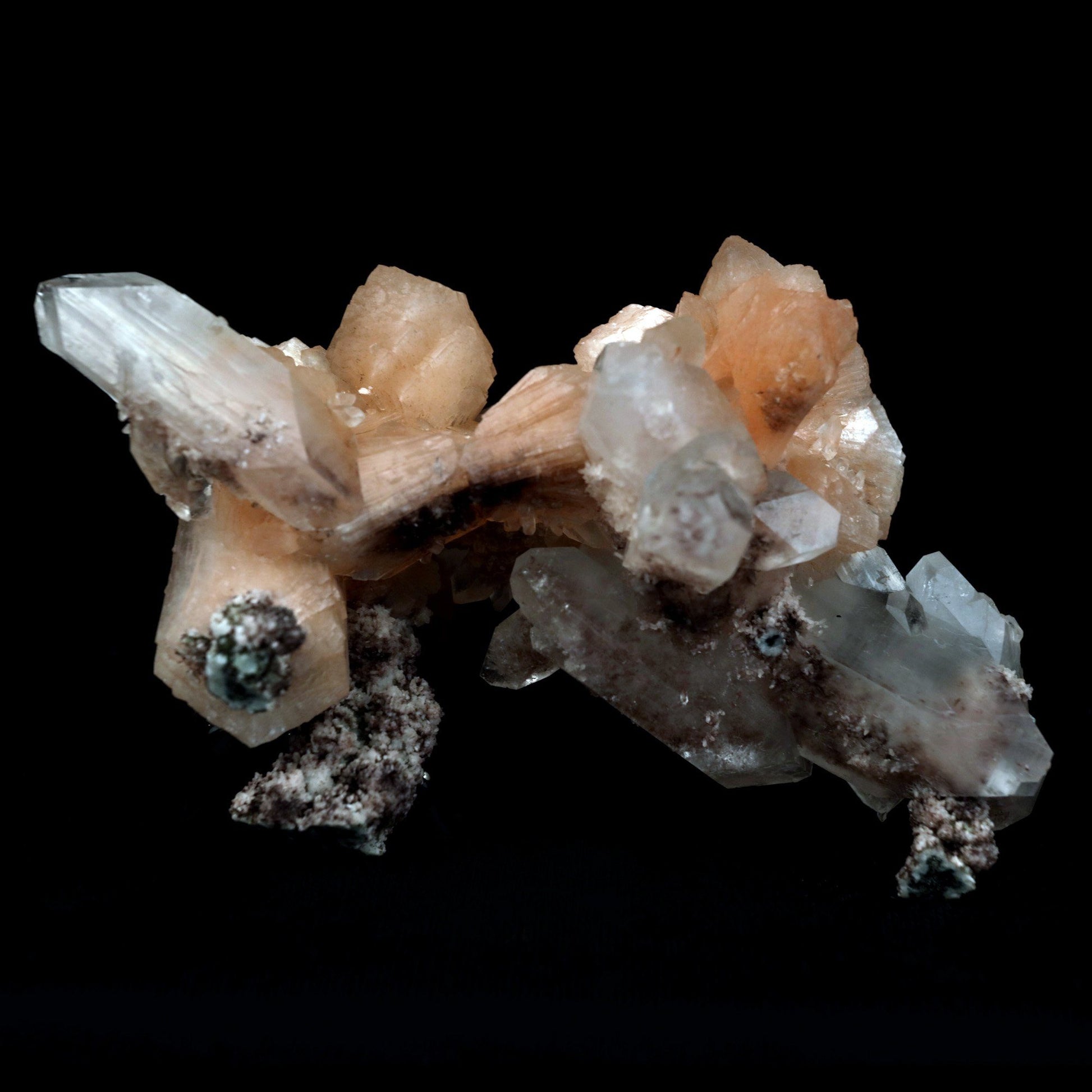 Terminated Stilbite with Apophyllite Natural Mineral Specimen # B 480…  https://www.superbminerals.us/products/terminated-stilbite-with-apophyllite-natural-mineral-specimen-b-4802  Features: Beautiful, classic salmon-pink, iridescent, translucent stilbite blades form a dramatic and sculptural huge two-sided specimen from Jalgaon, with sprakling Apophyllite crystals.The huge doubly ended bowtie on the back is eye-catching. The wormy, green celadonite-infused chalcedony matrix 