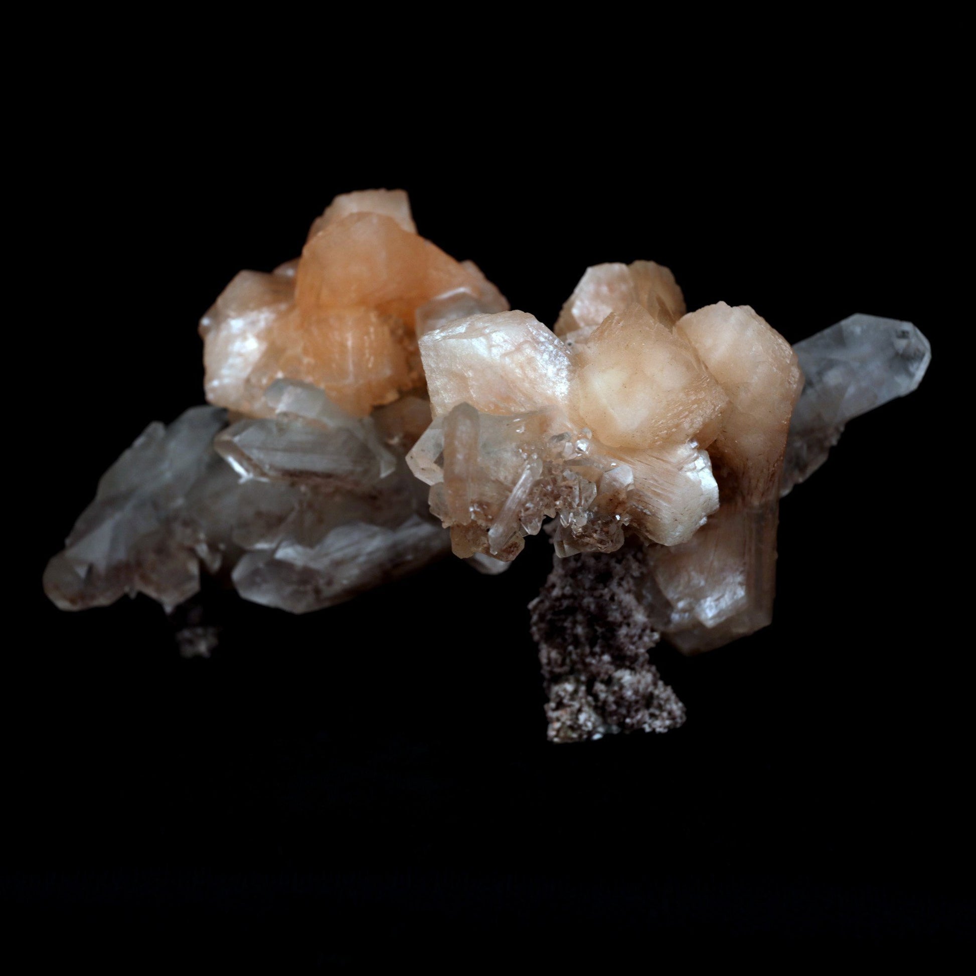 Terminated Stilbite with Apophyllite Natural Mineral Specimen # B 480…  https://www.superbminerals.us/products/terminated-stilbite-with-apophyllite-natural-mineral-specimen-b-4802  Features: Beautiful, classic salmon-pink, iridescent, translucent stilbite blades form a dramatic and sculptural huge two-sided specimen from Jalgaon, with sprakling Apophyllite crystals.The huge doubly ended bowtie on the back is eye-catching. The wormy, green celadonite-infused chalcedony matrix 